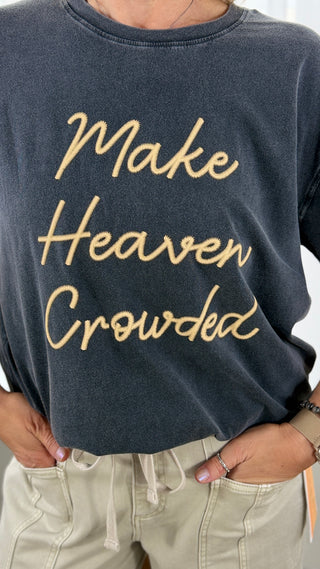 Black sweatshirt with 'Make Heaven Crowded' text in gold on a plain background