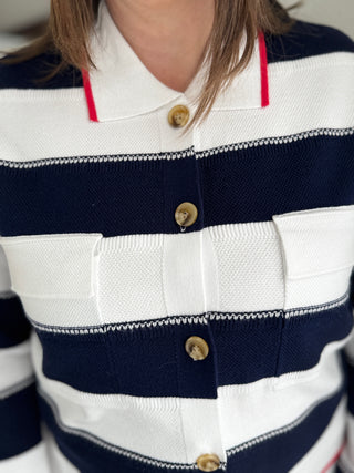 Close-up of a person wearing a striped shirt with navy, white, and red colors.