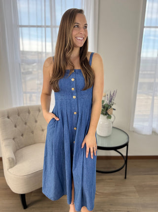 Woman wearing a blue denim dress in a living room setting