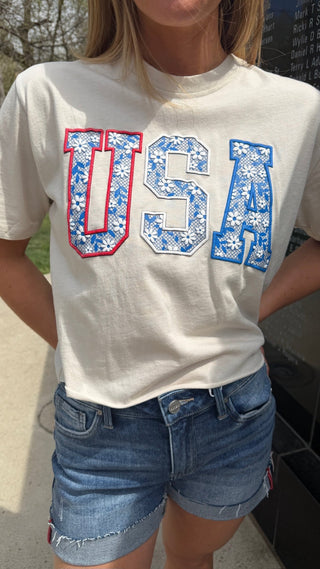 Woman wearing a USA crop tee shirt.
