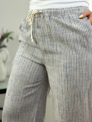 Close-up of gray striped pants with a blurred background