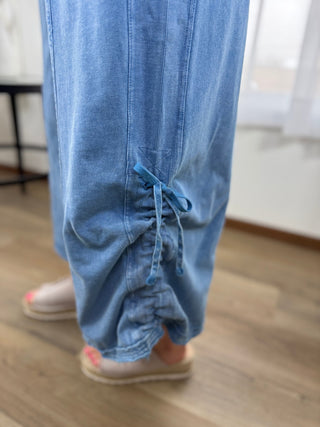 Blue jeans being worn with a blurred indoor background