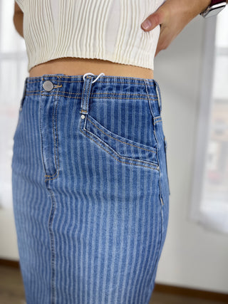 Person wearing blue jeans with a blurred background