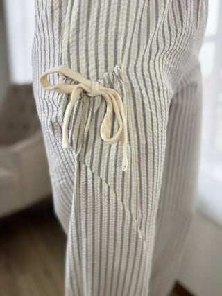 Striped pants with drawstring waist in a neutral setting