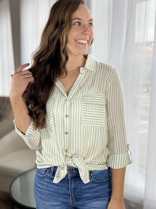 Woman wearing a striped shirt and jeans indoors