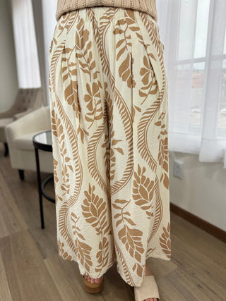 Beige patterned pants worn by a person indoors.