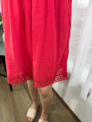 Red skirt with lace trim on a person, blurred background