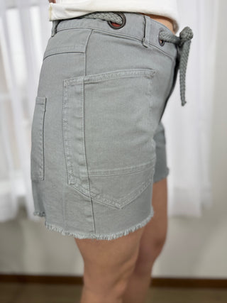 Light gray denim skirt worn by a person with a blurred background