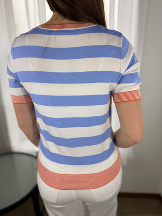 Person wearing a striped shirt with blue, white, and orange horizontal stripes.