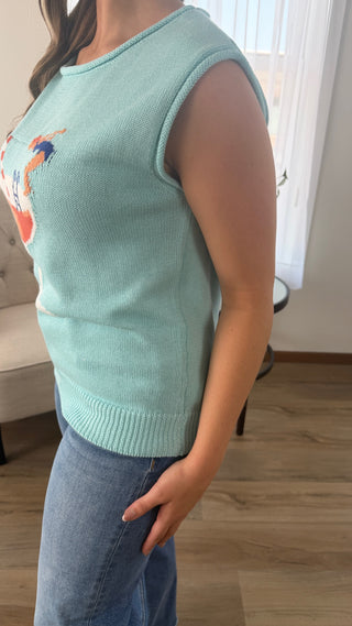 Photo of a woman wearing a graphic sweater.