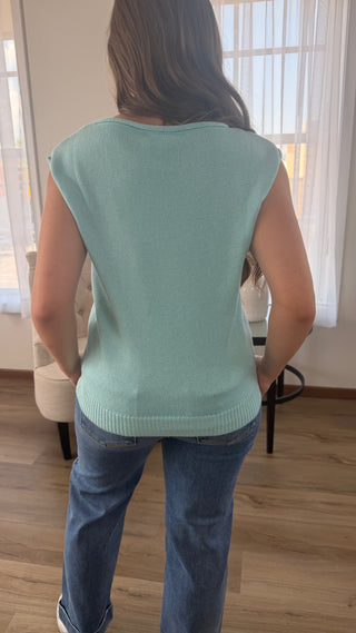 Photo of a woman wearing a graphic sweater.