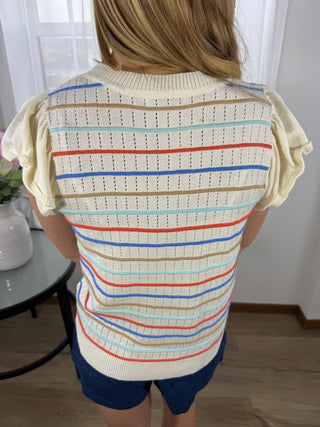 Person holding a striped fabric with colorful lines.