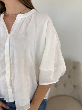 White blouse worn by a person with a blurred background