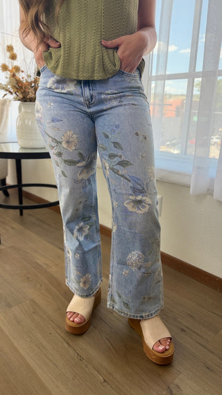 Model wearing floral jeans.