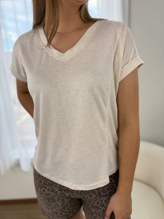 Woman is wearing a white blouse.