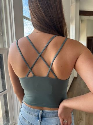 Woman wearing a criss cross tank.