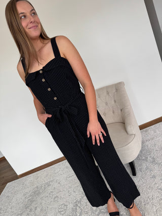 Model is wearing a jumpsuit.