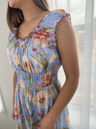 Model is wearing a floral jumpsuit.