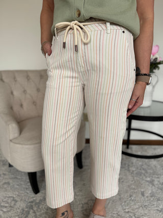 Woman standing wearing a multi stripe pant .