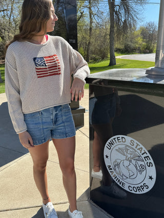 Woman wearing a knit flag top.
