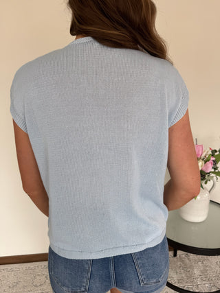 Woman wearing a top with lemon wedges on it.