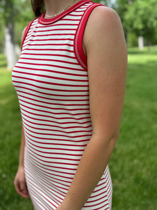 Person wearing a red and white striped dress in a park setting