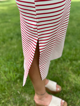 Red and white striped dress with a slit on a grassy background