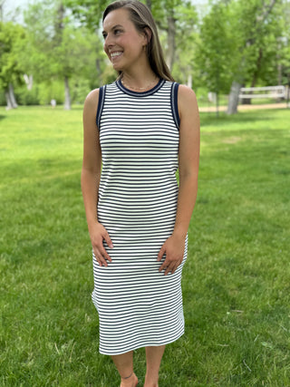 Woman wearing a striped dress standing in a park