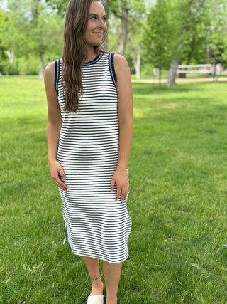 Woman wearing a striped dress standing in a park