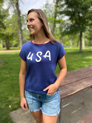 Woman wearing a blue 'USA' shirt in a park