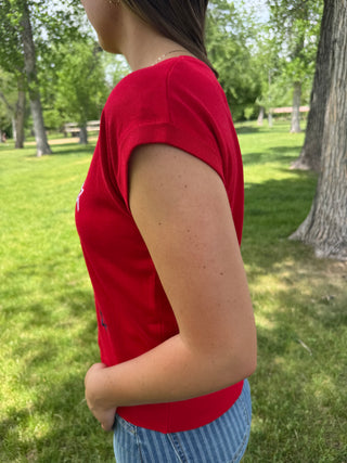 Person wearing a red shirt in a park setting