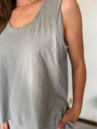Gray sleeveless top worn by a person with a neutral background