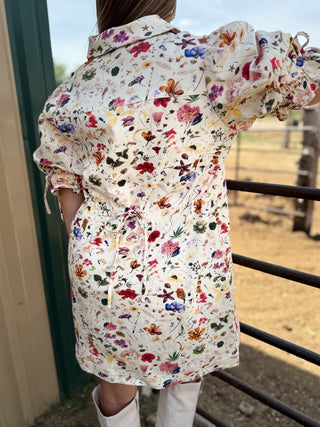 Person wearing a floral patterned shirt in an outdoor setting