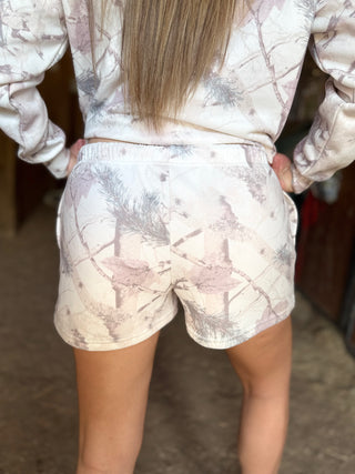 Person wearing a matching top and shorts set with a abstract pattern.