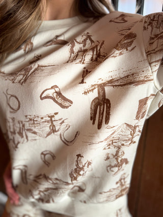 Person wearing a hoodie with a cowboy-themed pattern