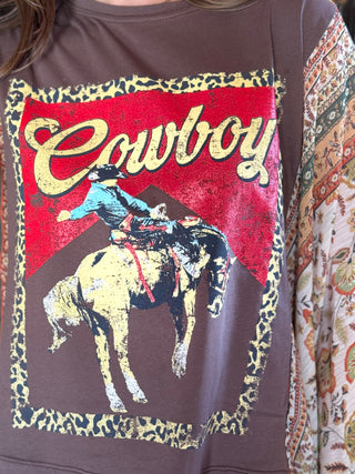 Sweatshirt with a cowboy graphic design on a brown background