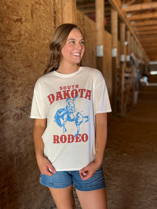 Woman wearing a 'South Dakota Rodeo' t-shirt in a barn setting