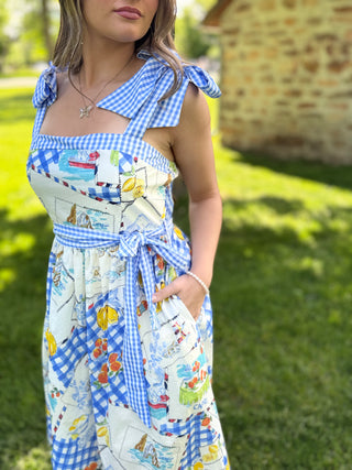 Woman wearing a colorful dress with a checkered pattern outdoors.