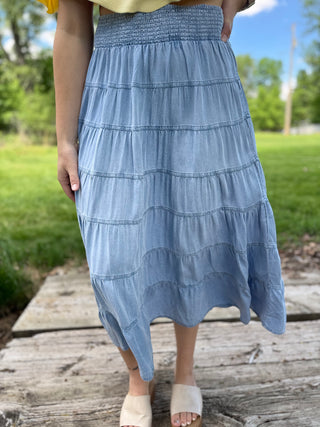Model wearing a tiered denim skirt.