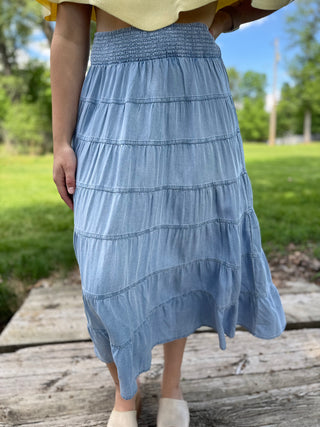 Model wearing a tiered denim skirt.