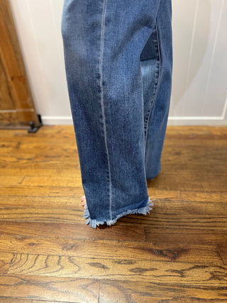 Blue jeans on a wooden floor