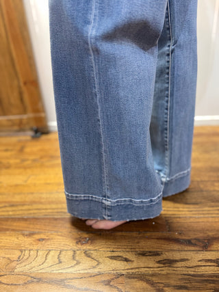 Blue jeans on a wooden floor