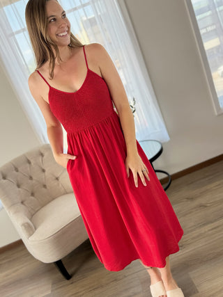 Photo of a woman wearing a red dress.