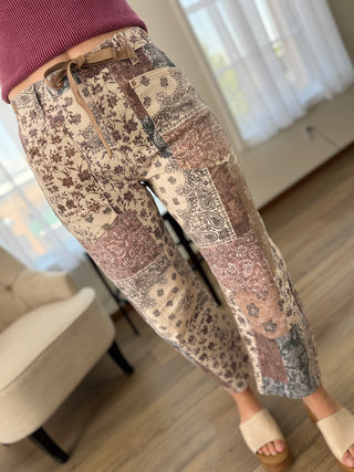 Lady standing wearing paisley print barrel jeans.