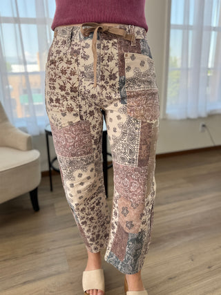 Lady standing wearing paisley print barrel jeans.