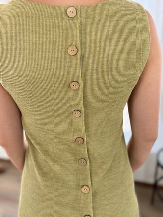 Close-up back view of a sleeveless ribbed knit top in a muted olive green color, featuring a vertical row of natural wood buttons down the center back.