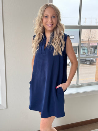 Wearing a blue dress.